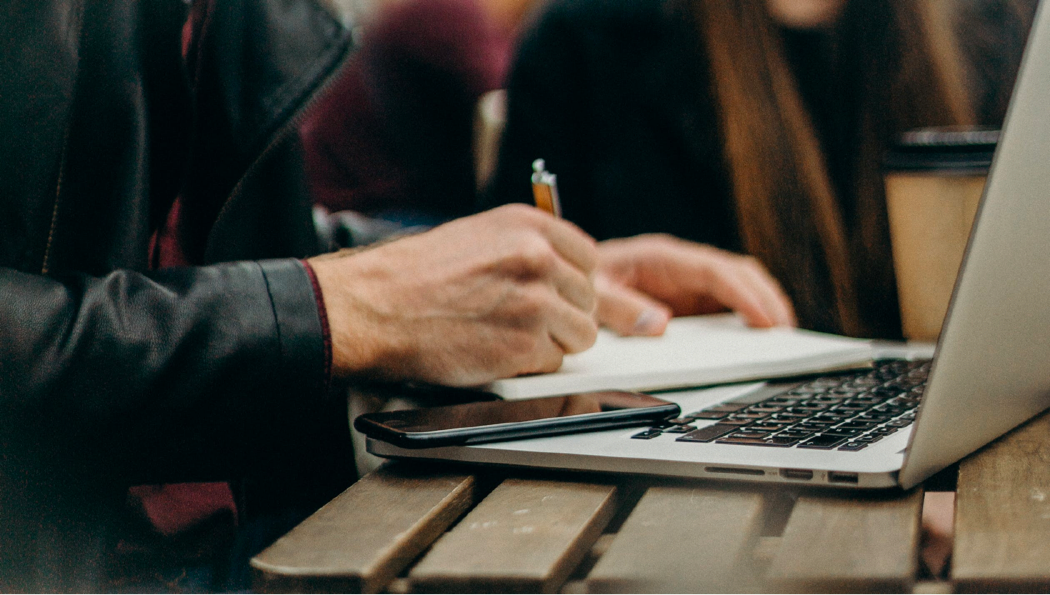 Person taking notes in notebook