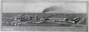 Illustration of the Western Electric Company, Hawthorne Works, showing a large industrial complex with multiple buildings, smokestacks emitting smoke, and surrounding infrastructure including roads and smaller structures. Text at the bottom reads: "WESTERN ELECTRIC COMPANY. HAWTHORNE WORKS."