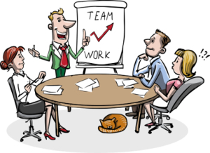 Cartoon illustration of a business meeting with four people seated around a round table covered in papers and pens. One person stands beside a flip chart displaying the words "TEAM" and "WORK" with an upward arrow between them. An orange cat is sleeping under the table.