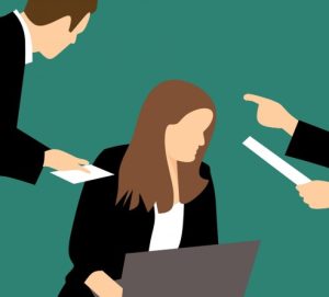 Illustration of three business-dressed individuals against a green background. One person is seated, working on a laptop, while the other two stand nearby—one handing over a piece of paper and the other pointing at a different document.