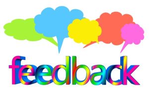 The word feedback is written in a rainbow gradient font. Above it are five speech bubbles in green, blue, yellow, orange, and pink.