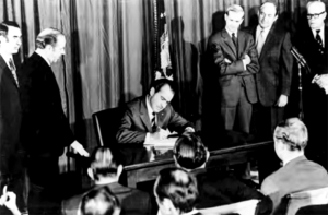 Nixon signing a law